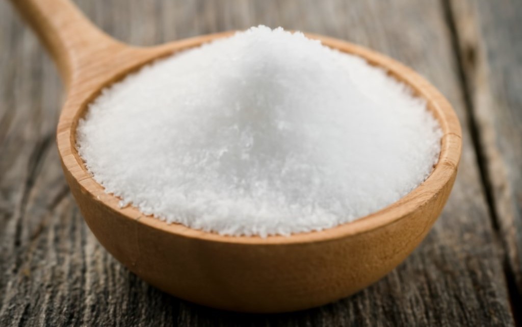A pile of salt grains representing sodium, a mineral essential for bodily functions and electrolyte balance.