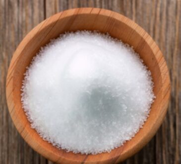 white chloride grains, resting on wooden table